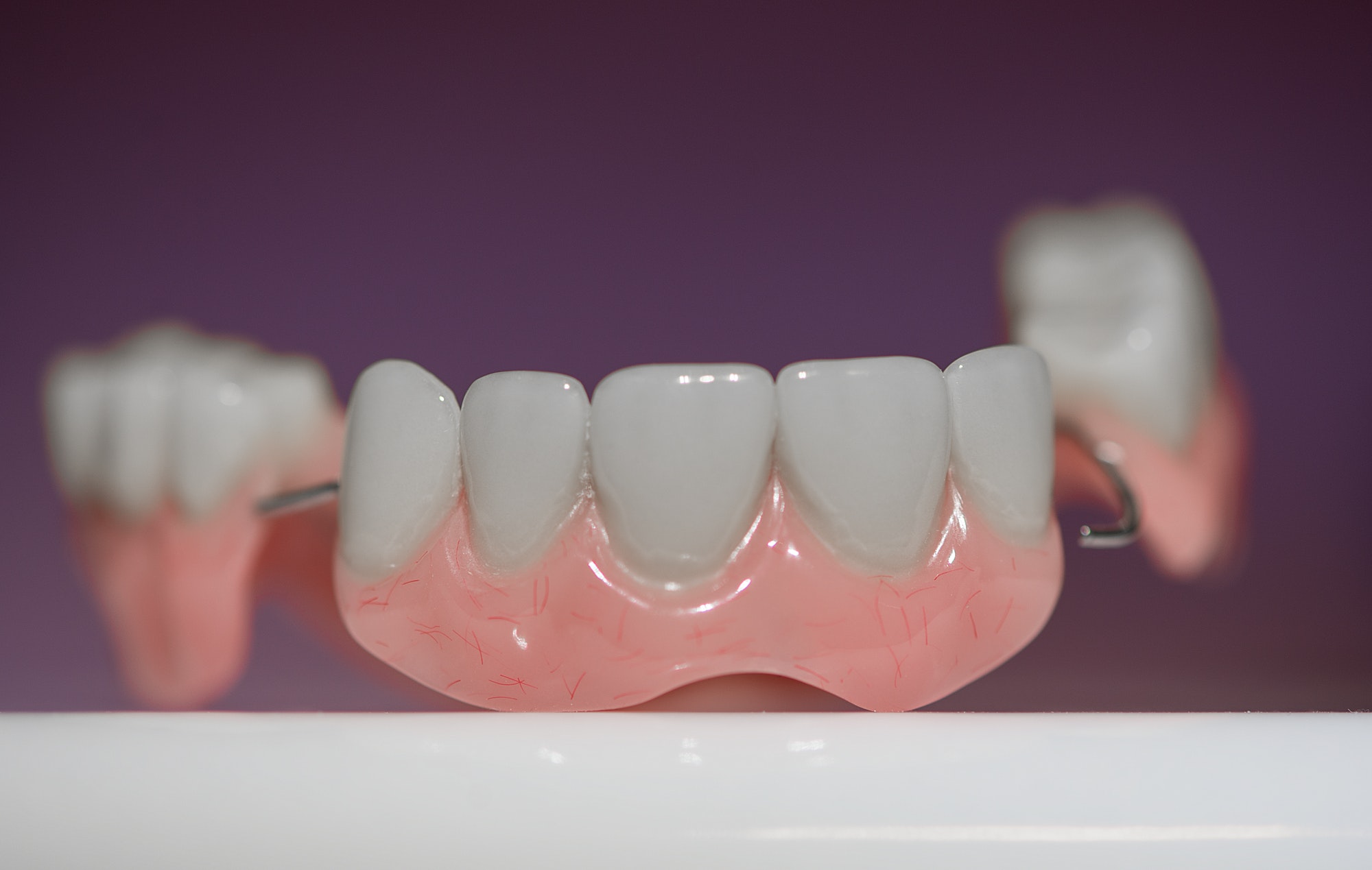 Dental prosthesis on purple background
